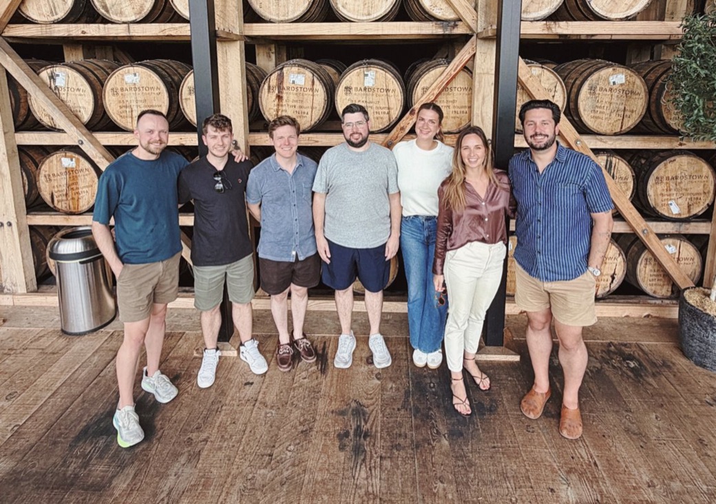 The Arrows team together at a bourbon distillery on a team offsite